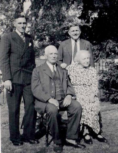 Alice and Ernest on the occasion of their Golden Wedding with their sons George (left) and Richard (right) in the garden of their cottage, Blackthorn Lodge,  on the Swaythling Estate.