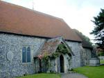 The pretty flint church at Eastdean - red tiled, low and reflecting the shape of local barns.